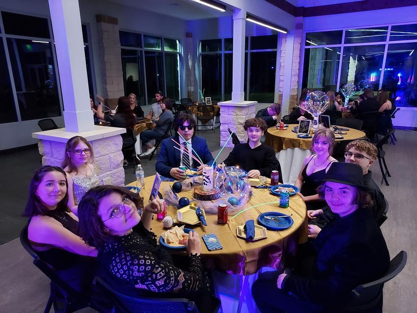 A group of people sitting around a table.